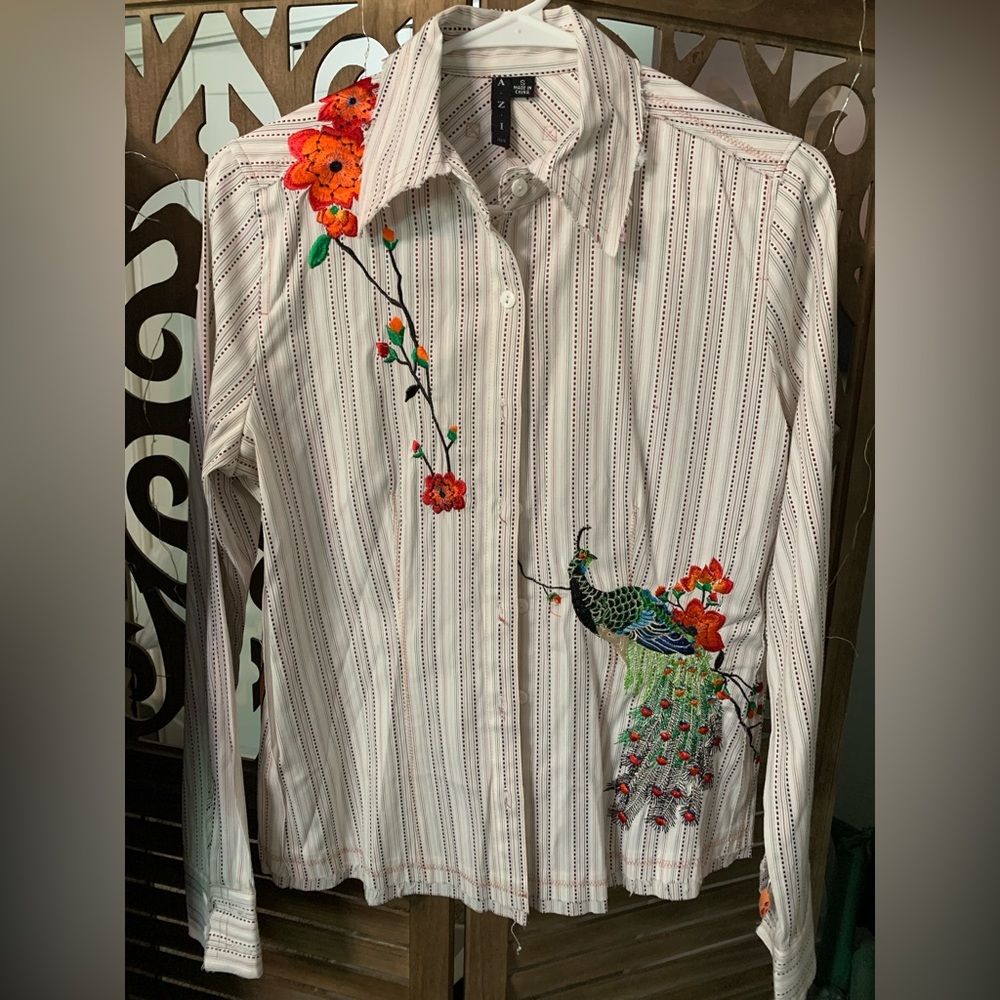 Embroidered long sleeve blouse with peacock and flower design.
